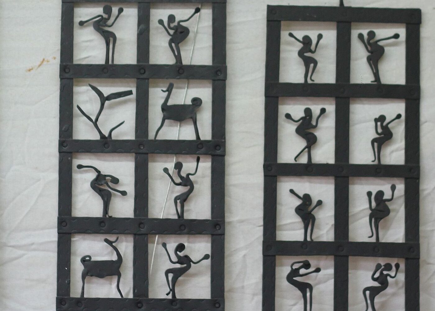 Traditional handcrafted tribal metalwork art panels with figures depicting rural life